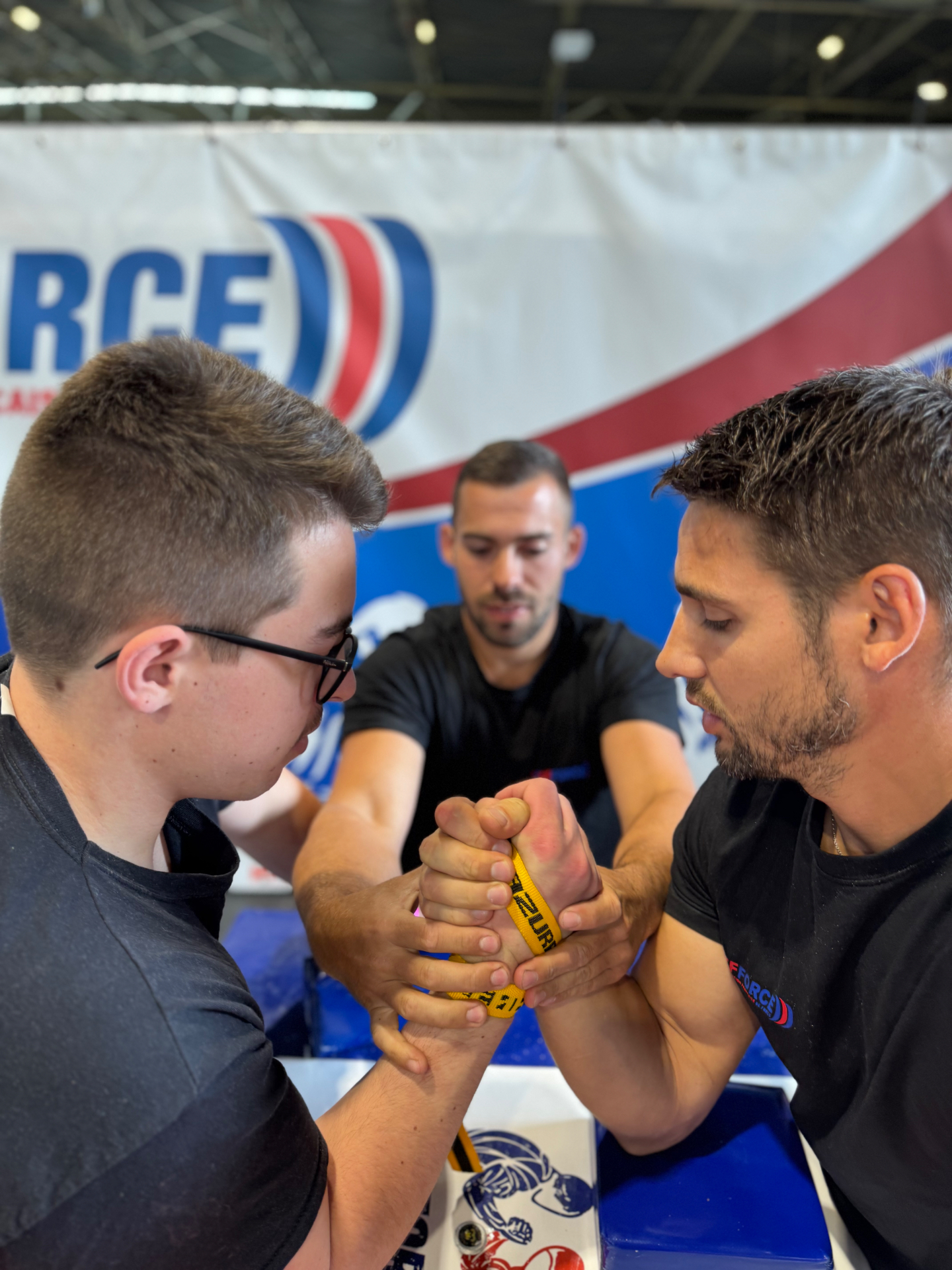 Athlètes du club à l'entraînement autour d'une table de bras de fer